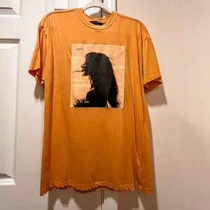 Yellow graphic t with profile of young woman with long hair